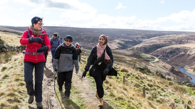 A group of walkers being led on a walk by a National Trust Ranger at Marsden Moor
